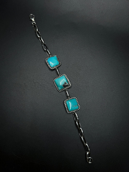 Bracelet with turquoise stones on a dark background
