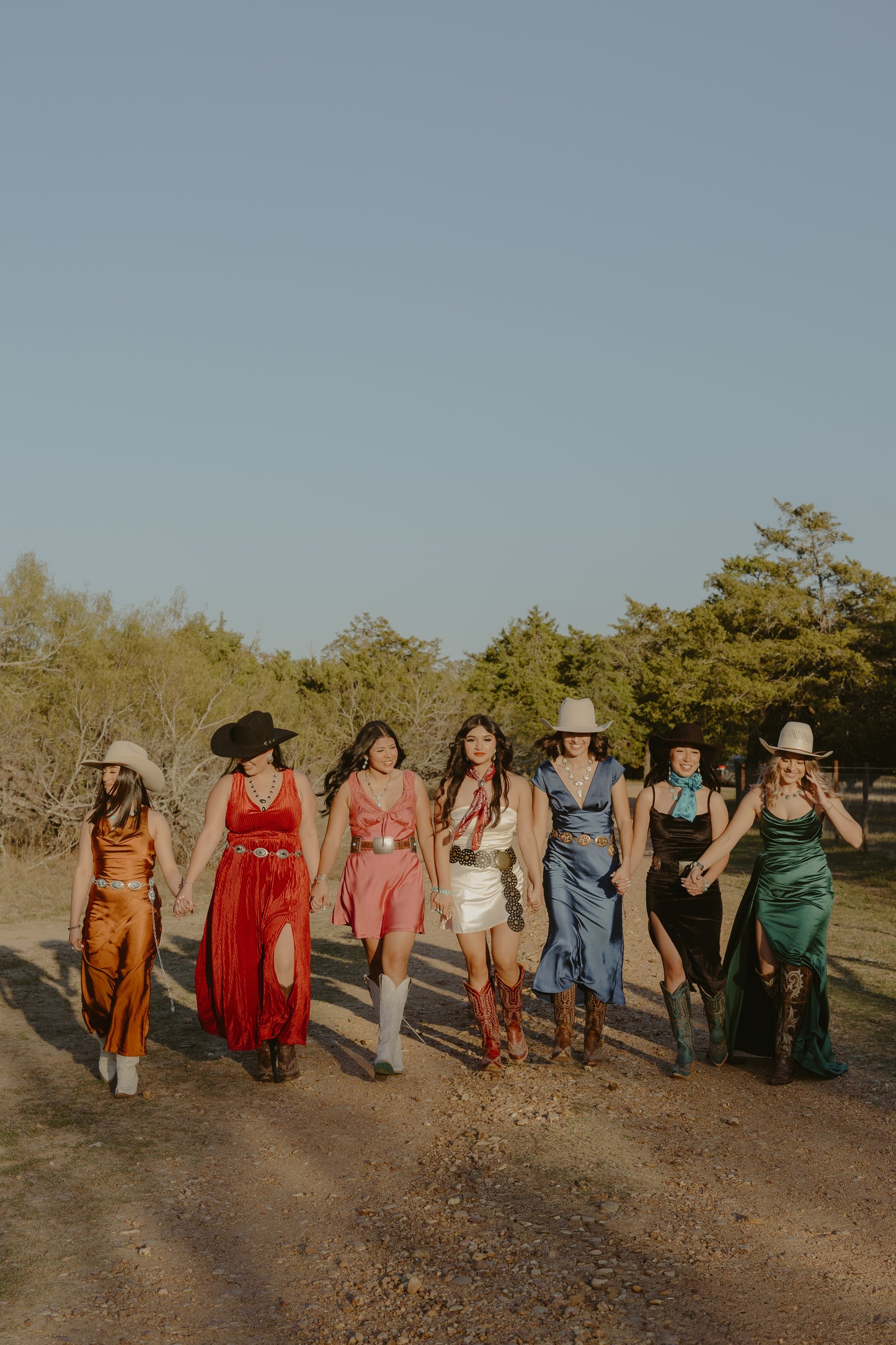 Group photo of models with jewelry and colorful dresses.